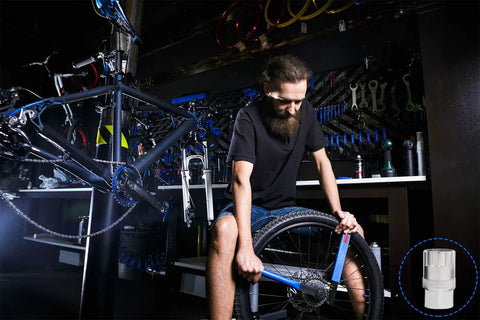 Mechanic using Bike Freewheel Removal And Lockring Tool For 12 Spline Freewheels Shimano SunRace, heavy duty alloy tool in workshop.