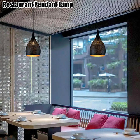 Industrial Wrought Iron Pendant Light Adjustable Single Head E27 Chandelier for Kitchen Island in a modern restaurant setting.