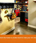 Top Shelf Matte Black Wall Coat Hooks Four Pack mounted on a wall holding tools, rope, and a bag in a workshop.