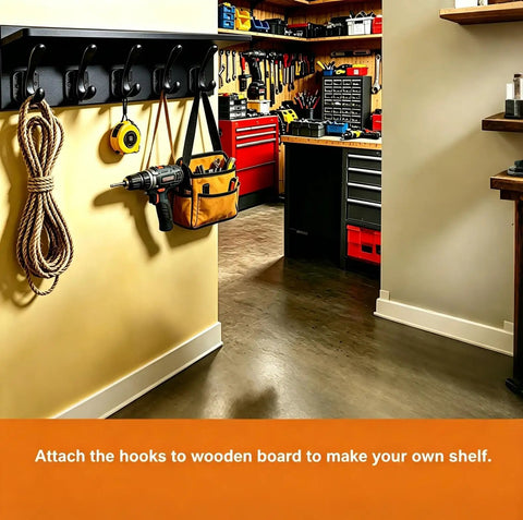 Top Shelf Matte Black Wall Coat Hooks Four Pack mounted on a wall holding tools, rope, and a bag in a workshop.