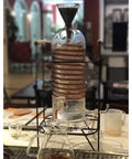 Next Level Glass Cold Brew Coffee Tower Featuring An Adjustable Speed Dripper And Clever Spiral Cooling Tube For Killer Iced Coffee Or Tea Effortlessly, 250ml, borosilicate glass, on display.