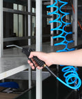 Solid As Nails 1/4 Inch By 25 Foot Polyurethane Coil Air Hose With Instant Spring Back Rewind and Heavy Duty Fittings in use with air nozzle.