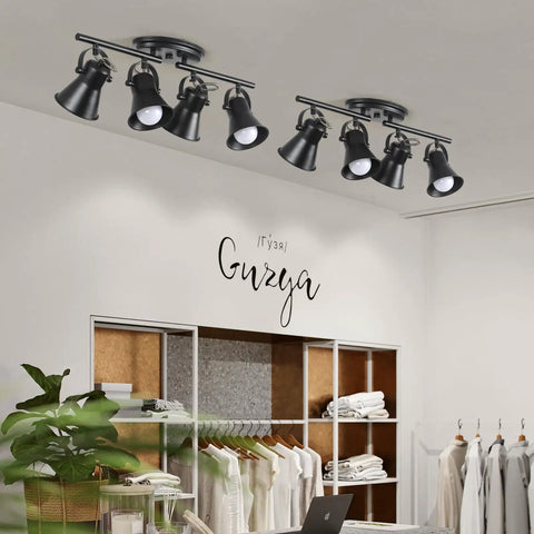 4 Light Track Lighting Kit In Industrial Black Finish With Adjustable Heads, installed in a modern room with white decor