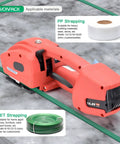 Hustle Free Electric Strapping Machine With Bright Digital Display And Massive 4000 Mah Battery Handles Half To Five Eighths In Poly Straps No Sweat Compact Cordless Bundler For Wood Metal Crate Packing on a surface with strapping rolls.