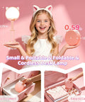 Girl holding Pink Foldable Desk Lamp for Dorm Rooms and College Girls Rechargeable and Dimmable Portable Cat Lamp