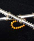 Close-up of Handmade Chinese Kung Fu Sword Pair With Stainless Steel Blade And Brass Fittings against a black background