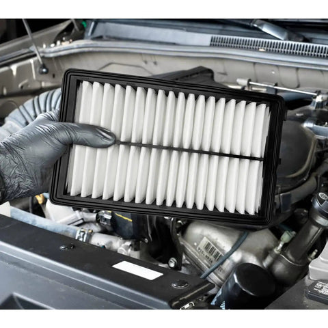 Mechanic holding Engine Air Filter Fits Kia Sorento 2021 To 2025, K5 2021 To 2025, Sportage 2023 To 2025 near car engine