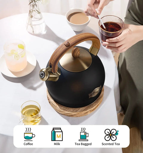 Induction Ready Whistling Tea Kettle and Teapot, 2.64 Qt Stainless Steel with Cool Touch Ergonomic Handle, Polished Black on table