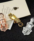 Gold Lady Hand Shaped Paper Clips With Dope Retro Style Binder Clips in assorted metals on black surface