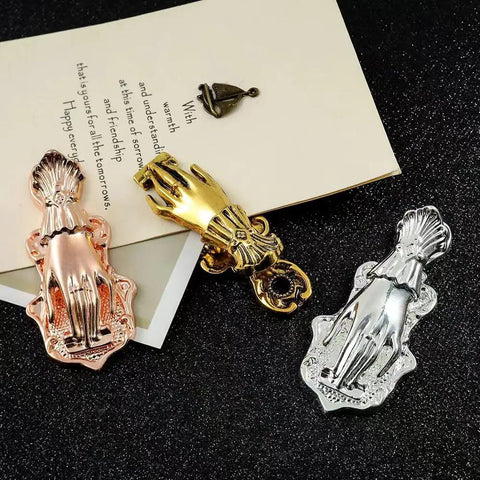 Gold Lady Hand Shaped Paper Clips With Dope Retro Style Binder Clips in assorted metals on black surface
