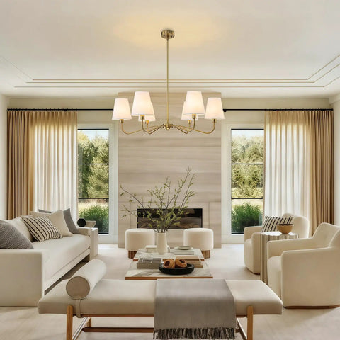 Smooth Operator 6 Light Brass Gold Chandelier With White Fabric Shades illuminating a bright dining area with modern decor.