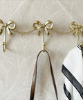 Kickass Heavy Duty Wall Mounted Coat Hook Bulletproof Metal Clothes Hanger with decorative bows, ideal for hanging bags and scarves.