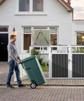 Man placing trash bin into Durable Metal Trash Can Enclosure For Three 50 Gallon Bins Heavy Duty Outdoor Storage Shed
