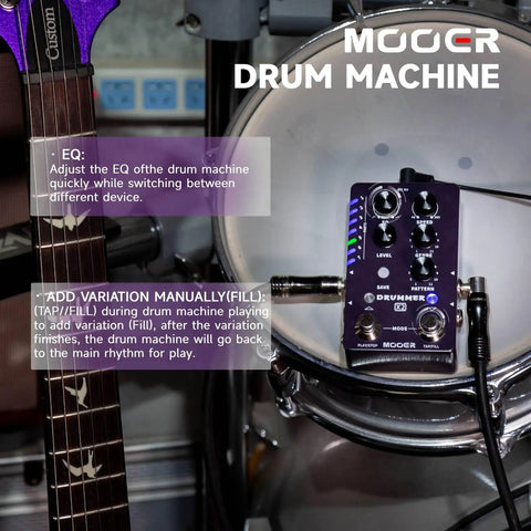 Drum Machine Pedal For Guitar And Bass With 121 Drum Grooves 11 Music Styles on drum kit beside electric guitar.