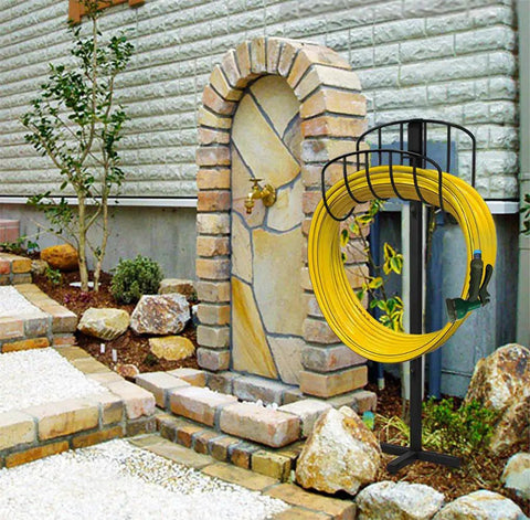 Freestanding Garden Hose Holder And Organizer Stand For Outdoor Use placed next to a stone wall holding a yellow hose
