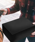 Person holding a black package in transaction, related to 100 Pcs 12 By 15.5 Inch Poly Mailer Envelopes Waterproof Self Adhesive Bags For Shipping Clothes.