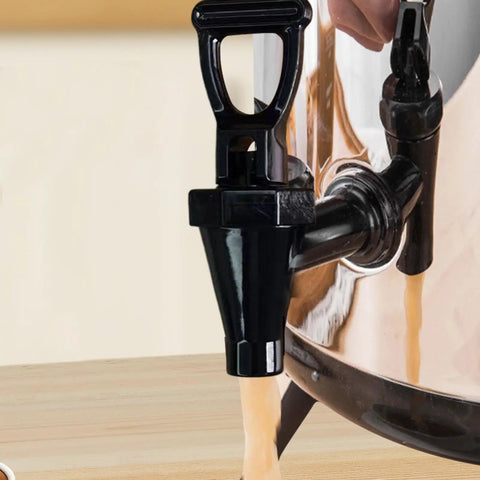 Close-up of Total Hype Tea Bucket Tap And Outdoor Water Spigot For Coffee Barrels, black polypropylene spigot dispensing beverage.