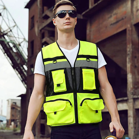 Heavy Duty High Visibility Safety Vest Featuring Breathable Mesh Lining Multiple Storage Pockets And Bright Fluorescent Yellow Fabric For Construction Crew Daily Grind And Rugged Shop Tested Workwear worn by man outdoors.