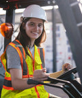 Person driving forklift wearing High Visibility Safety Vest With Pockets For Construction Pros ANSI Class 2 Type R Reflective Vest