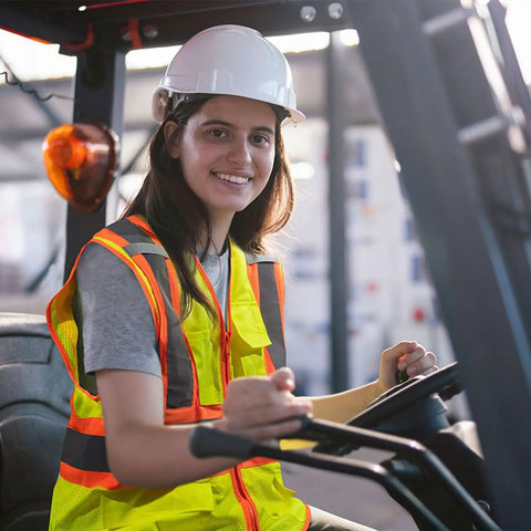 Person driving forklift wearing High Visibility Safety Vest With Pockets For Construction Pros ANSI Class 2 Type R Reflective Vest