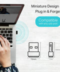 Nano AC600 USB WiFi Adapter Archer T2U Nano Dual Band inserted in laptop with hand, dimensions illustrated on side