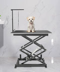 Built Like A Tank Electric Scissor Lift Table With Smooth Hydraulic Action And Wireless Remote For Easy Warehouse Material Handling Holds 180 Pounds Securely And Folds Flat For Storage with a dog on top.