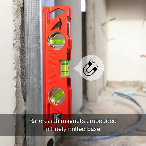 Rock Hard Professional Grade Cast Aluminum Torpedo Level With Magnetic Dual View Plumb Vial For Quick And Dirty Measuring And Tight Drywall Joint Layouts On Site showing rare-earth magnets on a wall.