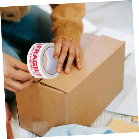 Person applying Fragile Warning Packing Tape Set With 5 Rolls, Heavy Duty Shipping Tape That Sticks Like Crazy, to box