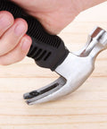 Close-up of a person holding an 8 Oz Stubby Claw Hammer Mini 6 Inch 4 Pack With Soft Rubber Grip Ergonomic Handle for home repair.