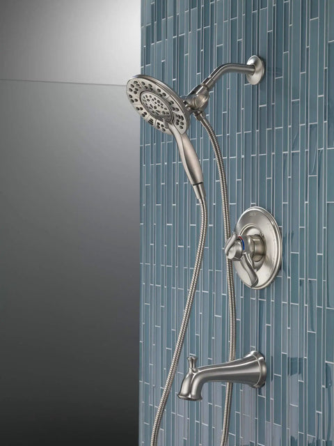 Linden 17 Series Dual Function Tub And Shower Trim Kit With In2ition 4 Spray 2 In 1 Handheld Shower Head And Hose Stainless Finish T17494 SS I Valve Not Included installed on blue tile wall