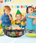 Black metal four-compartment snack organizer on countertop, spinning Lazy Susan with divider, filled with snack packets.