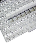 Close-up of open 0603 SMD Capacitor Kit with 101 values in compact enclosure, labeled compartments with free tweezers for prototyping