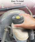 Hand installing Toyota Brake Master Cylinder Fluid Reservoir Cap Replacement With Beefed-Up Leak-Proof Seal on vehicle.