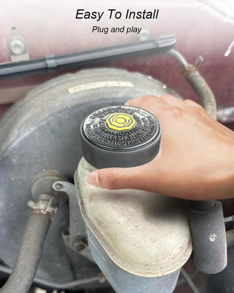 Hand installing Toyota Brake Master Cylinder Fluid Reservoir Cap Replacement With Beefed-Up Leak-Proof Seal on vehicle.