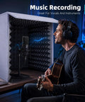 28 Inch Portable Vocal Recording Booth With Rock Solid Five Sided High Density Foam Soundproof Box For Home Creators To Lock In Perfect Vocal Acoustics For Podcasts Music And Vocals To Deliver Ultra Crisp Content used by a musician with a guitar.