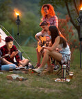 Six Pack Metal Citronella Torches For Outdoor Use 60 Inch Black Garden Yard Lights With Easy Refill Upgraded Design shown at a campsite