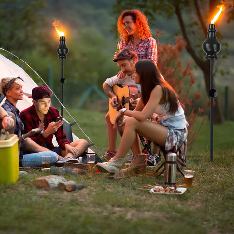 Six Pack Metal Citronella Torches For Outdoor Use 60 Inch Black Garden Yard Lights With Easy Refill Upgraded Design shown at a campsite