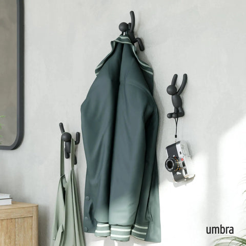 Buddy Wall Hooks Set of 3 Fun, Cool, Decorative Wall Mounted Coat Hooks in black holding jacket and camera