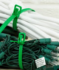 Heavy Duty Reusable Cable Ties With No Sweat Quick Release Lever Rock Solid Wire Control 275 Pound Pull Strength securing green cables.