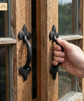 Old School Medieval Rustic Cast Iron Door Pull With Fleur De Lis Handle And Compact Grip, 7 1/8 Inch Decorative Hardware installed on wood door