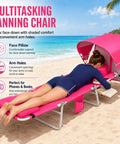 Outdoor Sunbathing Lounge Chair With Canopy Shade And Face Hole Padded And Washable Six Position Layout For Poolside Beach Or Lawn UPF 50 Plus Wind Resistant Sun Shade Patented Design, woman lying face down reading a book on a pink padded chair with canopy on the beach.