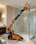 Electric Glass Vacuum Lifter With 360 Degree Rotation And Powerful Suction handling large glass panels in a bathroom setting.