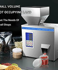 Game Changer Stainless Steel Automatic Powder Filling Machine For Seeds And Grains Compact Countertop Weighing Dispenser With Quiet Multi Point Vibration 50 Gram Capacity on countertop, showing control panel, grains, and packaging.