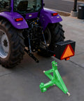 Heavy Duty Trailer Hitch Ball Mount With 10,000 Lbs Load Capacity And Locking Pins, Spray Coated Carbon Steel, Triple Hitch Balls For Trucks Trailers Farm And Utility Use, Green shown with a purple tractor on pavement.