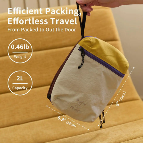 Water Resistant Travel Toiletry Bag With Hidden Carabiner Hook And Hanging Loop held by a hand, showing dimensions and weight.