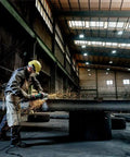 Worker using 9-Inch Angle Grinder With Lock-On Trigger, 6600 RPM, 15 Amp, W24-230 MVT for metalwork in industrial setting