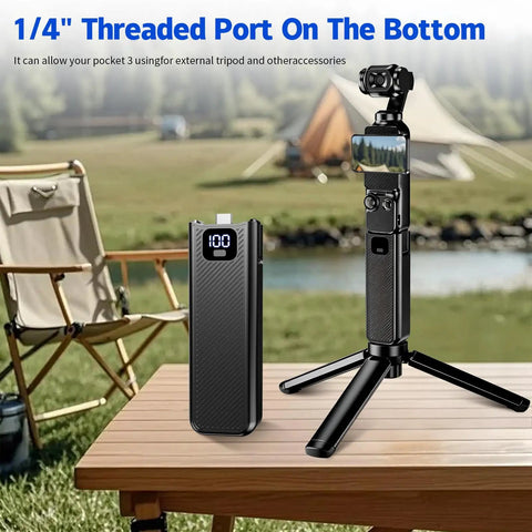 Power Up On The Go With A 5000mAh Battery Grip Featuring LED Digital Display For Osmo Pocket 4 And Pocket 3 Fast Charging One Quarter Inch Tripod Thread Type C Pass Through Durable Handheld Power Boost on a tripod outdoors.
