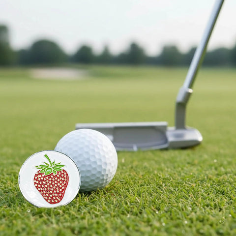Berry Inspired Golf Ball Marker With Alignment Marker For Putting Green Metallic Ball Marker Accessory Funny Strawberry Theme 1 Inch Wide Avid Golfer Gift For Any Round on grass near putter.