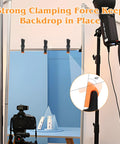 Heavy Duty 4.5 Inch Plastic Spring Clamps Set of 10 Backdrop Clips holding blue backdrop in photography studio setup