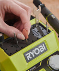Hand inserting a sanding drum into the Badass 18 Volt Cordless Mini Rotary Tool with 35 Premium Accessories.